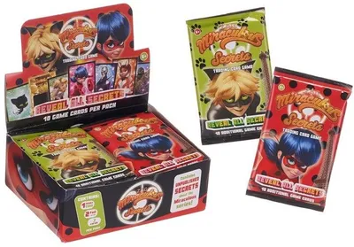 A display box of Miraculous Secrets trading card game booster packs, with two loose packs shown to the right.
