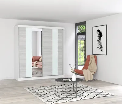 A modern bedroom or living room setting with a large sliding door wardrobe, a chair, a coffee table, and a rug.