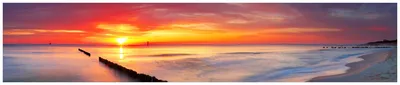 Produktbild von Wallario Küchenrückwand aus Glas, Größe: 250 x 50 cm, Motiv: Farbenspiel im Himmel - Sonnenuntergang am Strand | Spritzschutz | abwischbar | pflegeleicht | in
