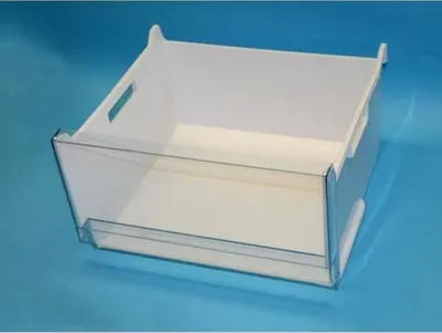 A white and clear plastic drawer for a refrigerator or freezer against a blue background.