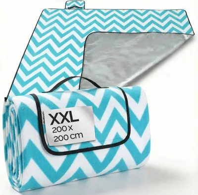 A folded picnic blanket with a chevron pattern and a label indicating its size.