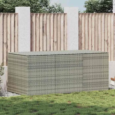 A poly rattan garden box is placed on a lawn in front of a wooden fence.