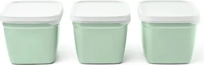 Three identical green containers with white lids are lined up against a white background.