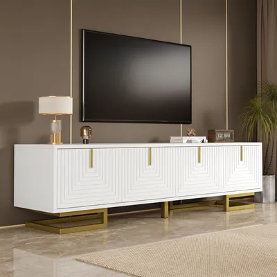 A white TV stand with gold accents is shown in a living room setting, with a large TV mounted above it.