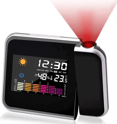 A digital alarm clock with a projection feature displaying time, date, temperature, and humidity.