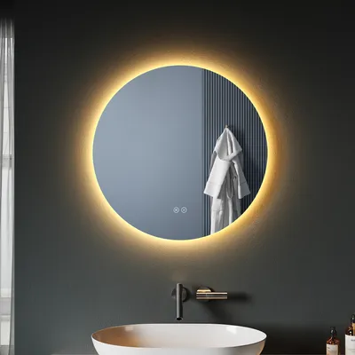 A round LED illuminated mirror above a sink in a modern bathroom.