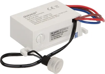 A white electronic device with wires and a sensor, likely a light sensor or motion detector, is shown against a white background.