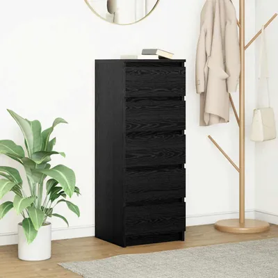 A black chest of drawers with a plant and a coat rack in the background.