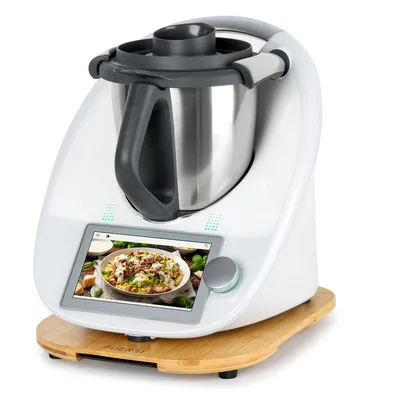 A white kitchen appliance with a touchscreen display showing a food image, resting on a wooden base.