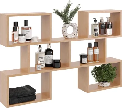 A modern, light wood-colored wall shelf unit displaying various bathroom and decorative items.