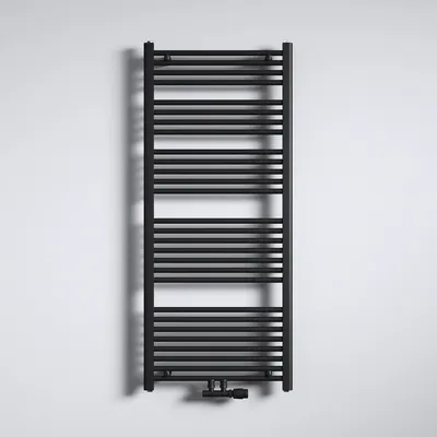 A black radiator is mounted on a white wall, casting a shadow.