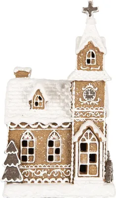 A gingerbread house decoration with snow and a cross on top.