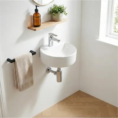 A clean, modern bathroom corner with a wall-mounted sink.