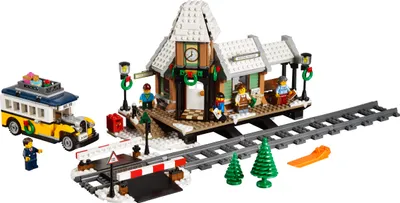 A LEGO Creator Winter Village Station set with a train track, station building, bus, and figures.