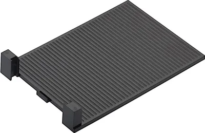 A black cutting board attachment with parallel grooves and two black plastic feet on one side.