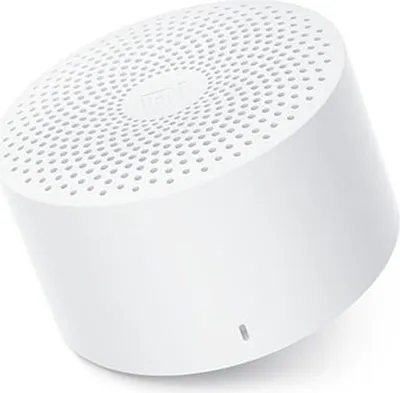 A white portable speaker shown from a three-quarter angle.