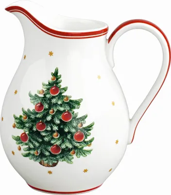 A white ceramic pitcher decorated with a Christmas tree and gold stars.