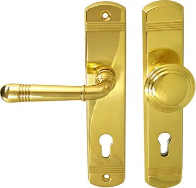 A pair of brass door handles and a door knob with keyhole plates, displayed against a white background.