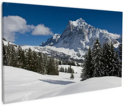 Produktbild von Wallario Premium Leinwandbild Verschneiter Berghang unter blauem Himmel in Größe 60 x 90 cm