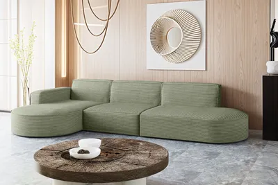 A modern living room with a sectional sofa, coffee table, and wall art.