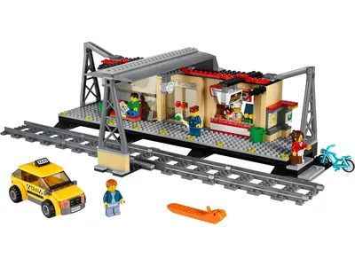 A LEGO City train station set with a taxi, figures, and accessories.