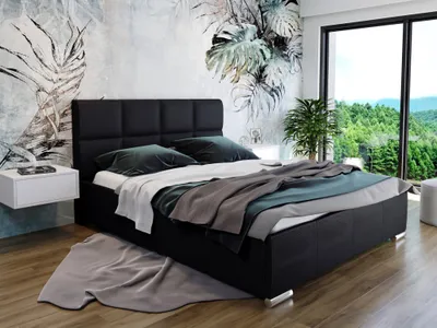 A bedroom with a large bed, a window overlooking a forest, and a floral wallpaper.