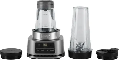 A Ninja stand mixer with two blending cups and lids, displayed on a white background.
