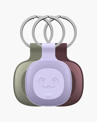 Three keychains with trackers in different colors are displayed against a white background.