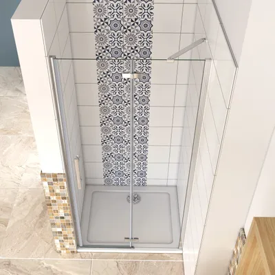 A shower enclosure with a patterned tile accent wall and a light-colored floor.