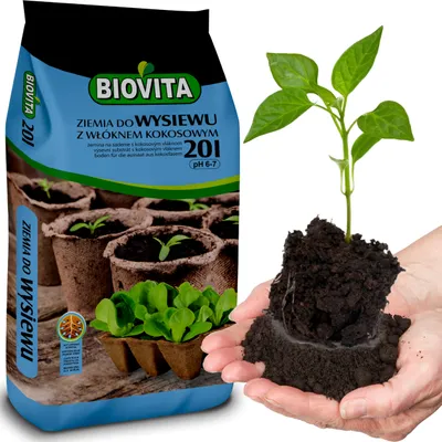 A bag of soil for sowing with coconut fiber and a young plant being held in hands.
