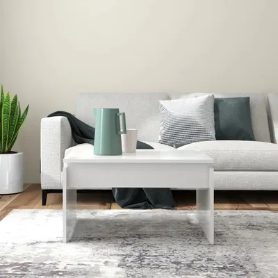 A living room scene with a couch, coffee table, and plant.