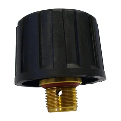 A close-up studio shot of a black and gold tank cap with a red O-ring.