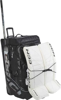 A hockey goalie bag and leg pads are shown against a white background.
