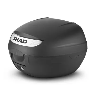 A black SHAD topcase for a motorcycle, shown from a front-side angle on a white background.