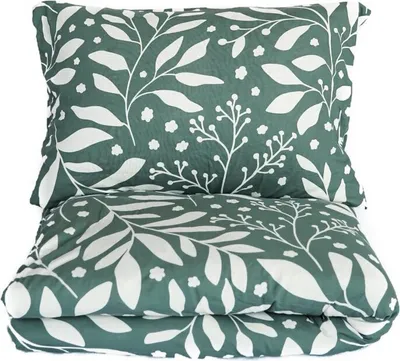 A folded duvet and pillow with a green and white floral pattern.