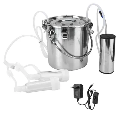 A stainless steel milking machine with its accessories and power adapter, laid out on a white background.