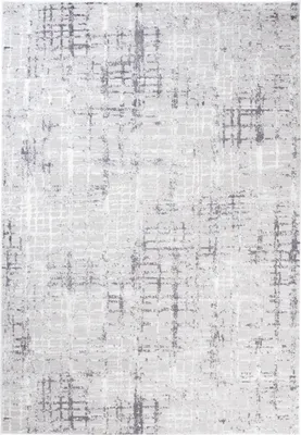 A close-up, top-down view of a rug with a distressed, abstract pattern.
