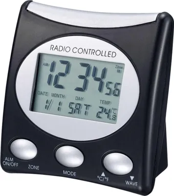 A digital alarm clock with a black plastic casing and a silver trim around the display.