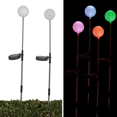 A split image showing solar-powered LED garden lights. The left side shows two lights with white globes on a white background, while the right side shows four lights with different colored globes (pink, orange, green, blue) on a black background.