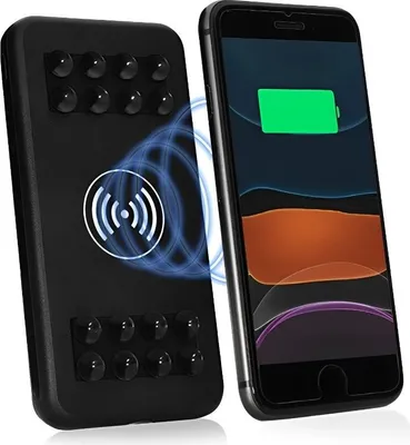 A black wireless power bank is shown next to a smartphone that is wirelessly charging.