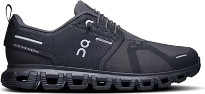 A side view of a black running shoe against a white background.