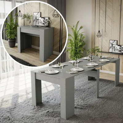 A dining table set up in a modern living room with plants and decor.