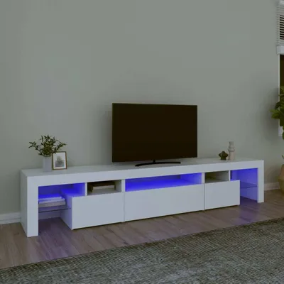 A modern white media console with blue LED lighting under shelves, in front of a gray wall.