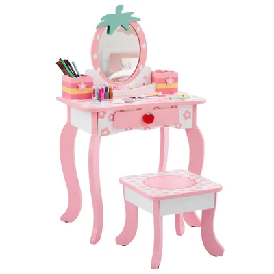 A child's pink vanity table and stool set with a strawberry-themed mirror and accessories.