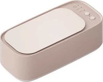 A top-down angled view of a pink ultrasonic cleaner with a white lid and control panel.