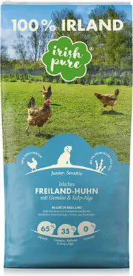 A bag of dog food with chickens in a field on the packaging.