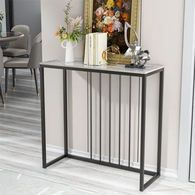 A console table with decorative items on top, placed in a room with dining chairs and a table in the background.