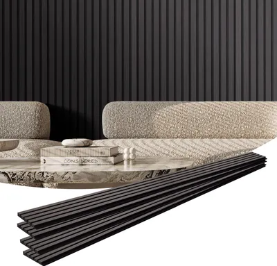 A modern living room setting with a sofa and coffee table, featuring a wall of dark slatted panels. Several dark wooden slats are laid out in the foreground.
