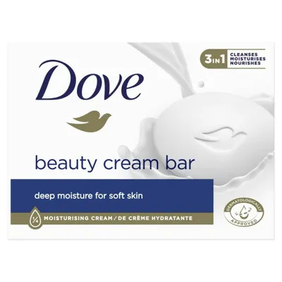 A Dove beauty cream bar soap with milk splashing around it.