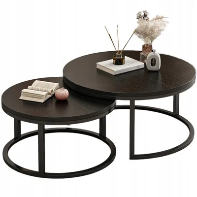 Two round coffee tables stacked on a white background.
